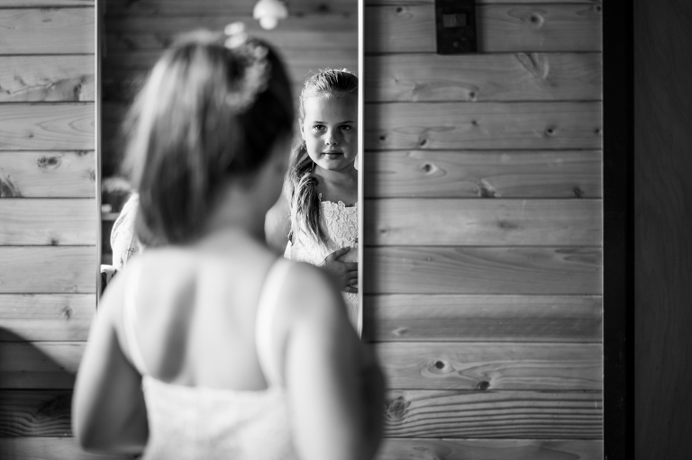 Flower girl looking in mirror